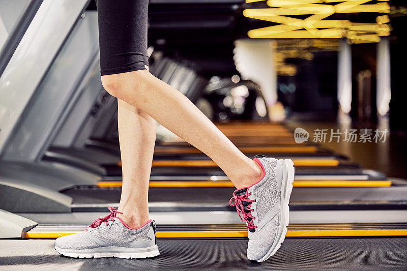 Fitness girl running on treadmill